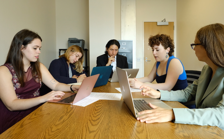 Students sitting around a table in discussion